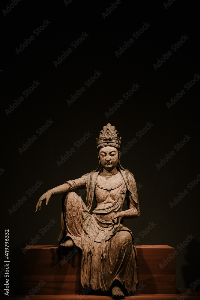 Buddha statue at Honolulu Museum of Art, Oahu, Hawaii. A Guanyin Bodhisattva woodcarved Buddha statue from the Song Dynasty, China.