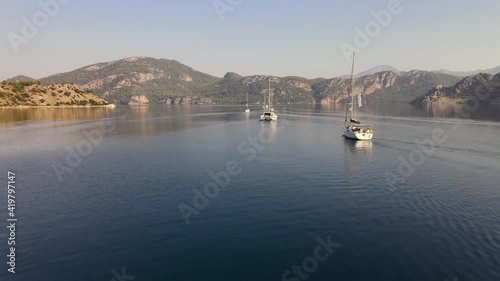 Group Of Sailboats Floating In Strait Ordered In Line 4K Video
 photo