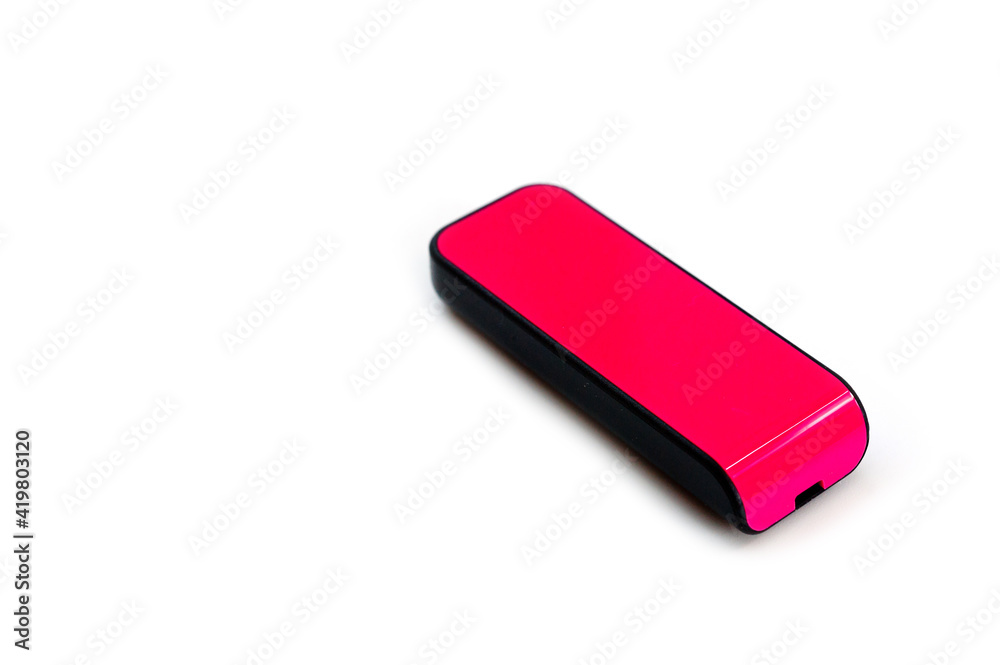 A pink USB flash drive with a plastic case, shot against a white background. A pink USB flash drive with a plastic case, shot against a white background.