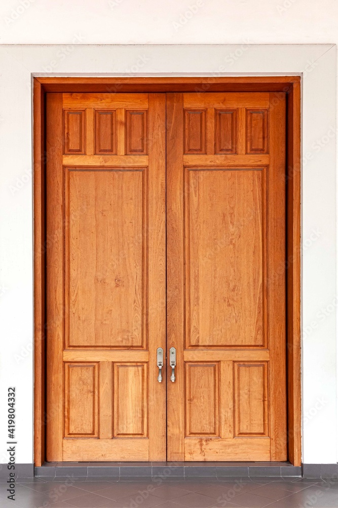 Large teak wood doors light brown entrance to the meeting room