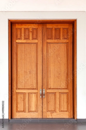 Large teak wood doors light brown entrance to the meeting room