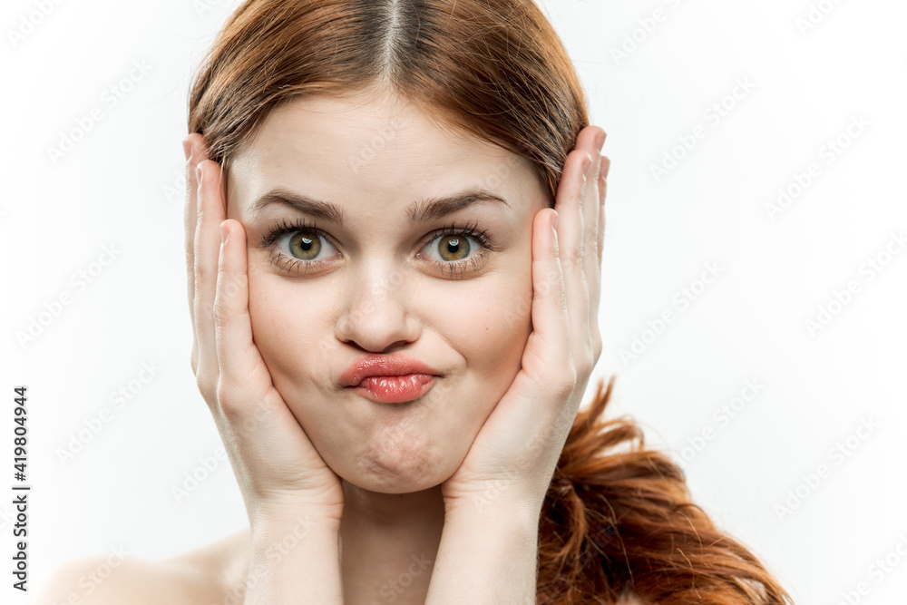 emotional cheerful woman holding hands near face attractive look emotional cheerful woman holding hands near face attractive look