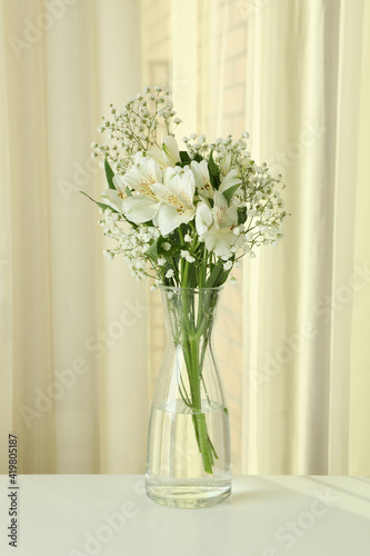 Vase with beautiful alstroemeria and gypsophila flowers