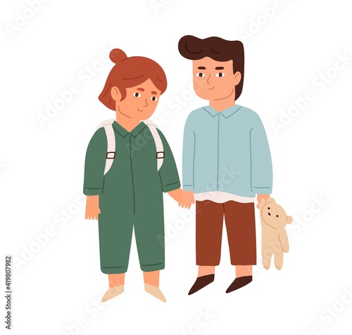 Couple of happy little children standing together and holding hands. Portrait...