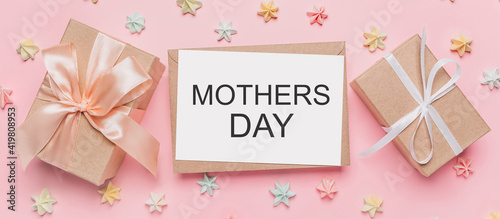 Gifts with note letter on isolated pink background with sweets, love and valentine concept with text mothers Day