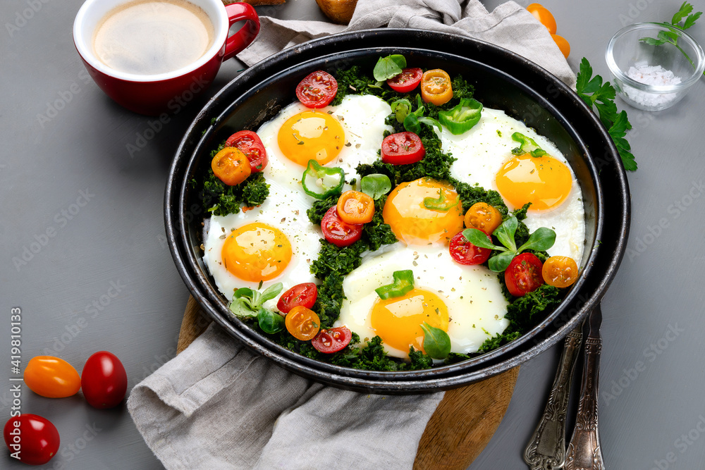 Fried eggs in frying pan for breakfast. Grey background Fried eggs in frying pan for breakfast. Grey background