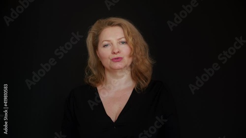 Portrait view of woman in black and with black background who performs on the stage