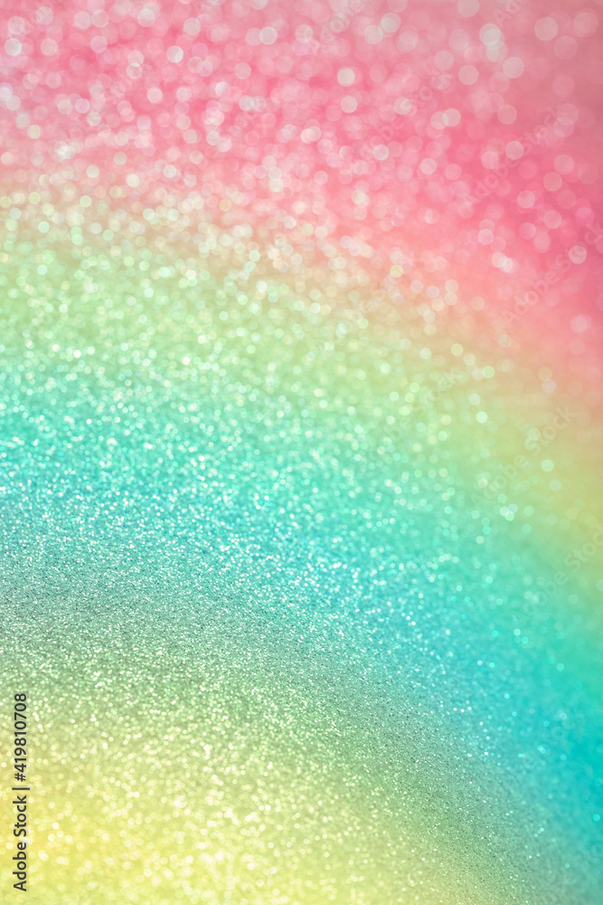 Sparkling glitter vertical background. Abstract texture of shiny grainy paper with gradient pink, green and yellow dusting