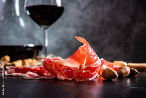 Iberian Ham. acorn-fed Iberian ham. Iberian ham with a glass of wine photo