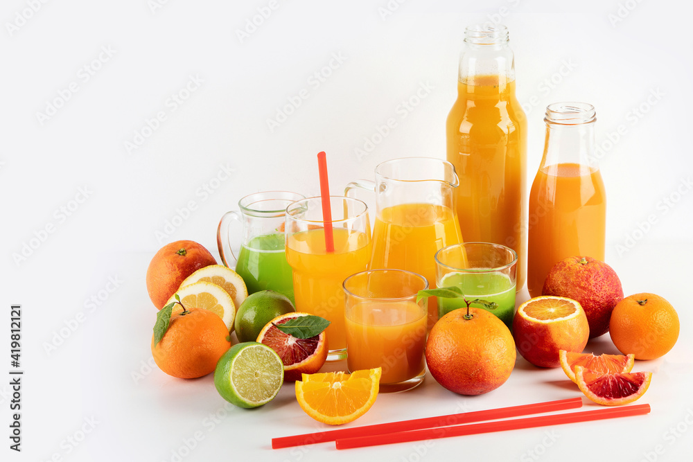 Variety of citrus juices and fruits on white background Variety of citrus juices and fruits on white background