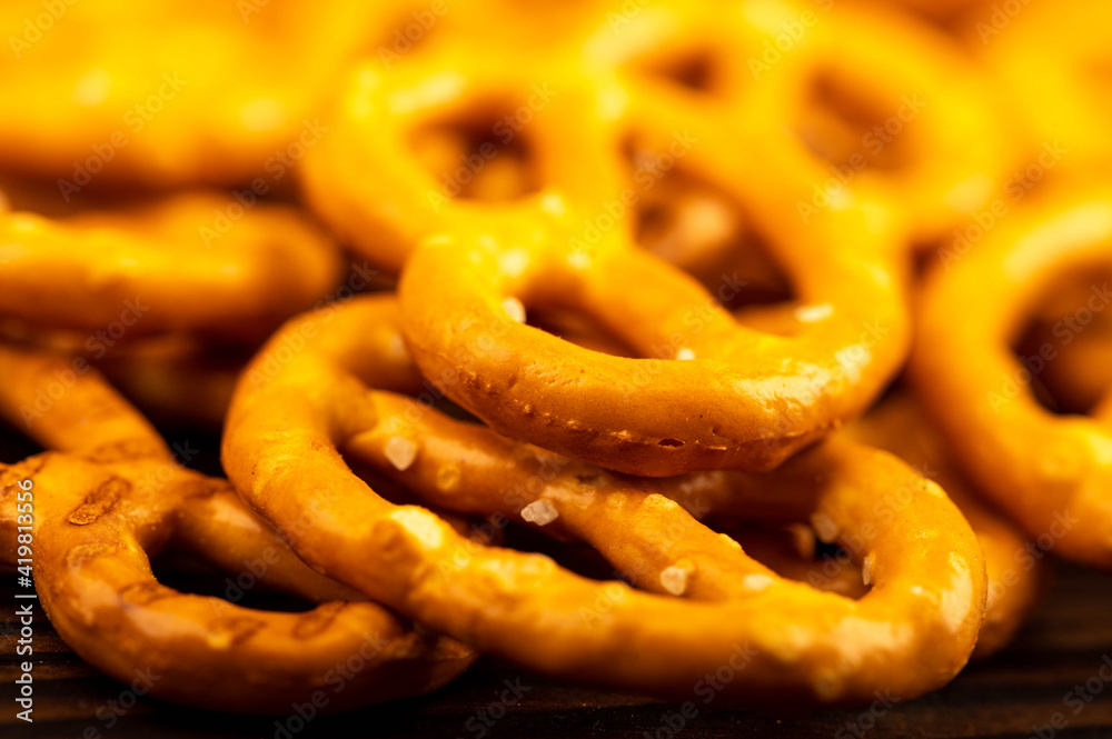 Salted breadsticks and salted pretzels scattered on the table. Salted breadsticks and salted pretzels scattered on the table.