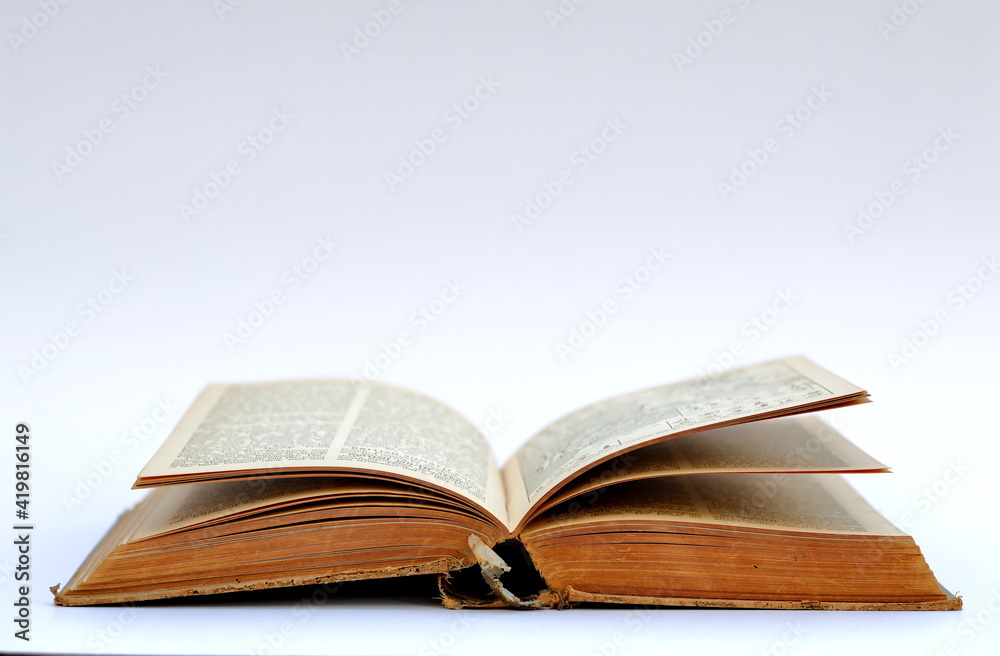 Open old book with text on white background Open old book with text on white background