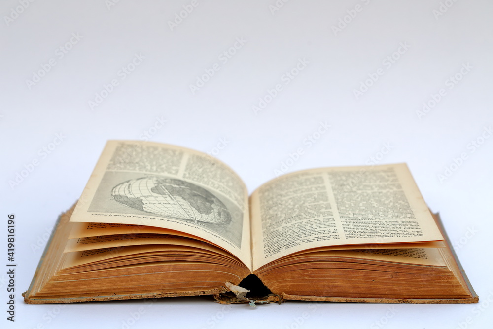 Open old book with text on white background
