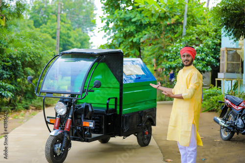 Obraz na plátně Young indian man standing with garbage van