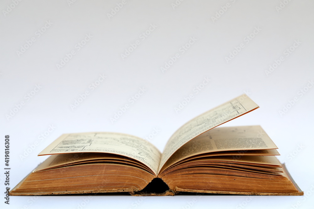 Open old book with text on white background Open old book with text on white background