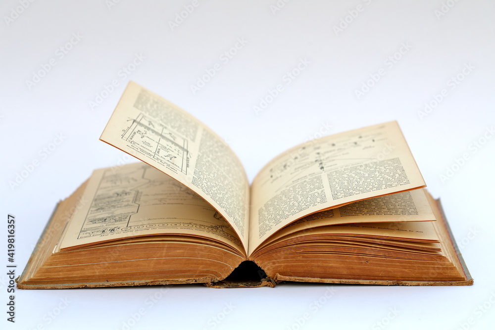 Open old book with text on white background Open old book with text on white background