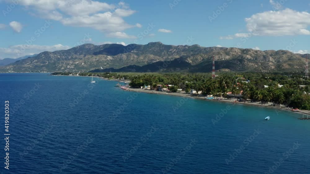 Palmar de Ocoa beach, Azua, against rolling hills and blue sky. Aerial view Palmar de Ocoa beach, Azua, against rolling hills and blue sky. Aerial view