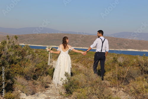 Hands joining towards the sea in Alaçatı, wedding photo
