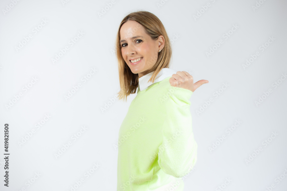 Close up side profile photo beautiful amazing pretty lady arm hand thumb finger indicate empty space wear casual sweater isolated pink background Close up side profile photo beautiful amazing pretty lady arm hand thumb finger indicate empty space wear casual sweater isolated pink background