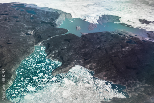 Active glacier from the top view, the birthplace of icebergs, Shore and glacier, permafrost, Greenland photo