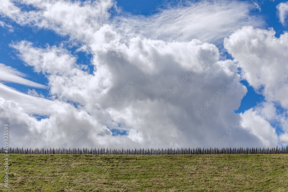 Landscape panorama of field and a beautiful blue sky with cumulus clouds