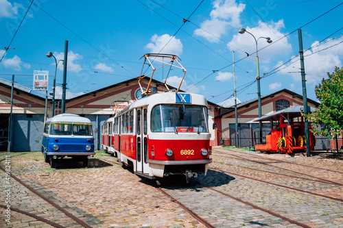Red vintage tram on the street in Prague. Public transport concept. The Prague tram network is the third largest in the world.