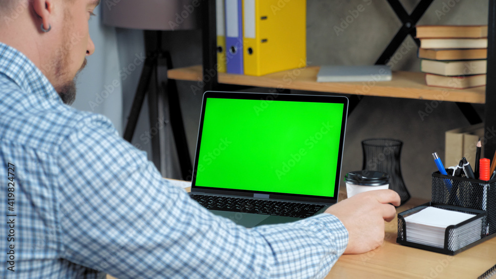 Green screen mock up chroma key display monitor laptop computer concept: Businessman at home office listen company top manager employee online remote conference webcam video call business meeting chat