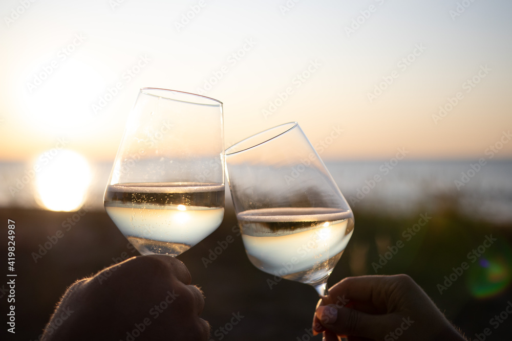 Celebrating Life. Two Glasses of Wine in the Sunset by Baltic Sea. Latvia
