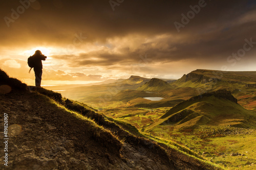 Scenic view of Quiraing mountains in Isle of Skye  Scottish highlands  United Kingdom. Sunrise time with colourful an rayini clouds in background.