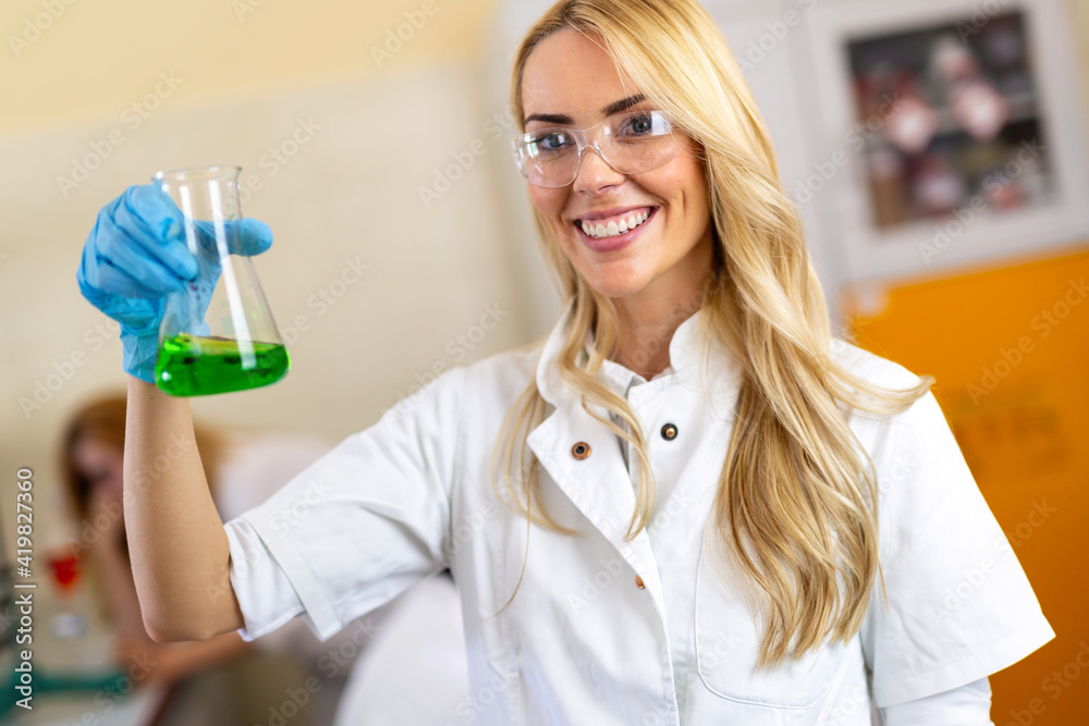 Serious clinicians studying chemical elements in laboratory Serious clinicians studying chemical elements in laboratory