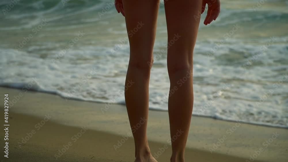 Beautiful happy woman on the beach in a swimsuit. A young girl runs along the ocean under the rays of the sun. Merry vacation at Kazat and dawn with sea waves. High quality FullHD footage Beautiful happy woman on the beach in a swimsuit. A young girl runs along the ocean under the rays of the sun. Merry vacation at Kazat and dawn with sea waves. High quality FullHD footage