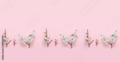 Spring nature background with white flowers on a pink