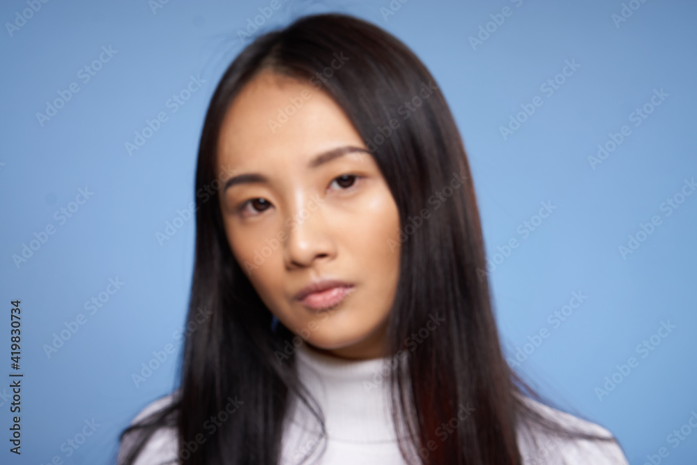 pretty woman asian appearance attractive look cropped view blue background pretty woman asian appearance attractive look cropped view blue background