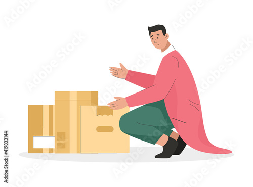 Man holding cardboard box with things. Young guy packing belongings in many boxes