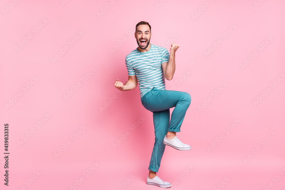 Full length body size view of attractive successful cheerful guy dancing having fun celebrating victory isolated over pink pastel color background