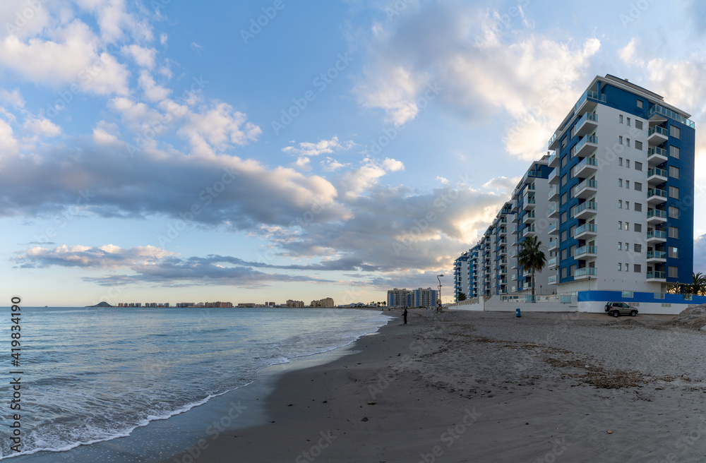 empty beach and hotels in La Manga del Mar Menor in Murcia under an expressive evening sky empty beach and hotels in La Manga del Mar Menor in Murcia under an expressive evening sky