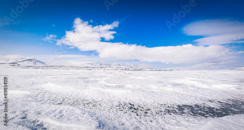 Panoramic view frozen Paravani lake in winter in sunny day.Tranquil winter landcape