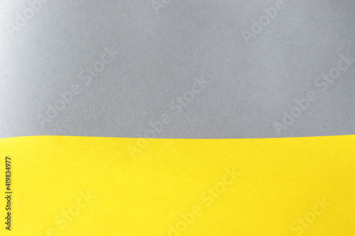 empty illuminate yellow and grey paper background. colour trend of the year 2021