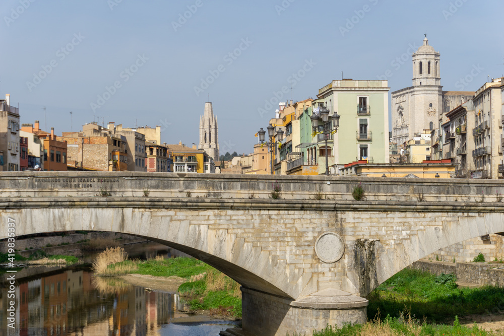 the historic old city center of Girona in northern Spain with ist many colorful buildings along the banks of the Onyar River