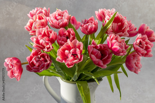 Pink Tulips bouquet in a white vase 