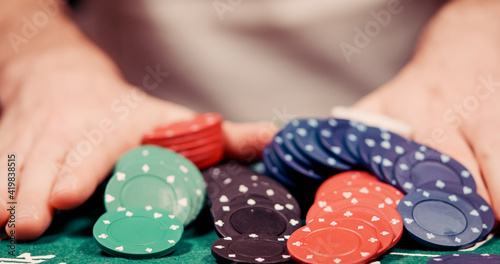 Fotografie Close up of gambler pushing his chips all in towards the cam