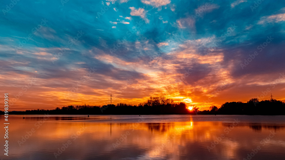 Beautiful autumn or indian summer sunset with reflections near Plattling, Isar, Bavaria, Germany