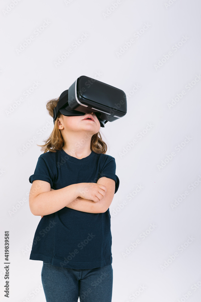 Little girl with virtual reality glasses looking up on white background Little girl with virtual reality glasses looking up on white background