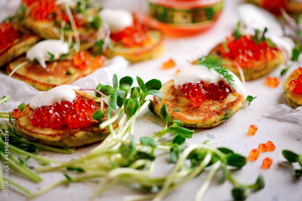 Potato pancakes with caviar.top view.style rustic