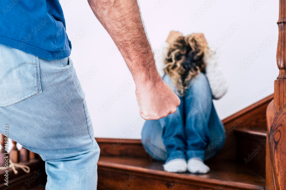 Man hand close up ready to beat up his woman sitting on the ground and  protecting herself - domestic violence abuse aggression crime concept for  couple problems Stock-Foto | Adobe Stock