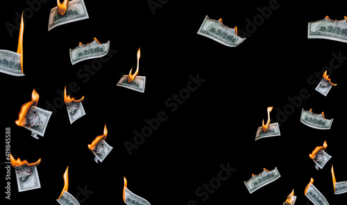 Fotografie Several 100 dollar bills, falling down, burn on a black background