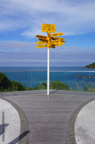 Global Signpost in Stirling Point showing direction and distance to cities around the World, Bluff, New Zealand