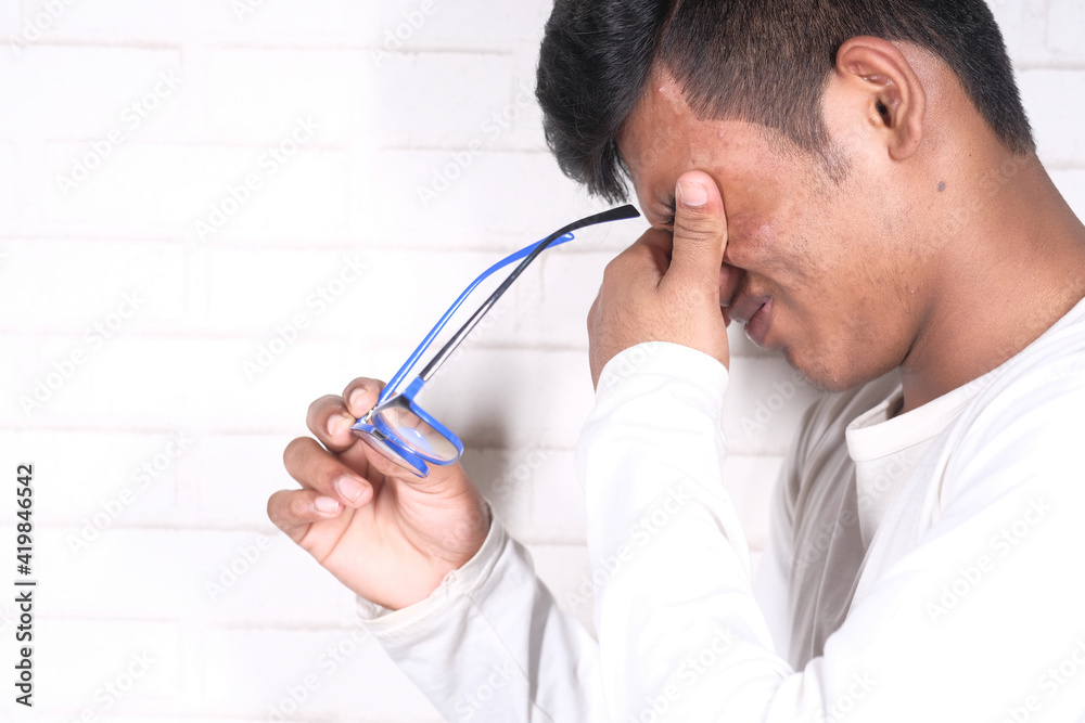 Close up of upset man suffering from strong eye pain Close up of upset man suffering from strong eye pain