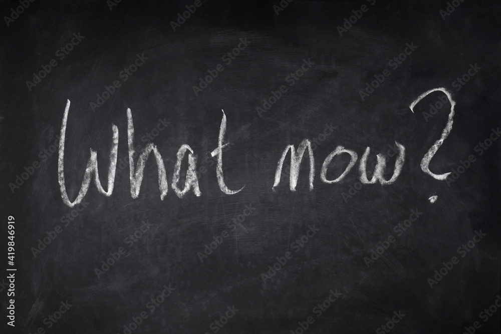 Fototapeta premium what now handwritten question on chalkboard - uncertainty, angst