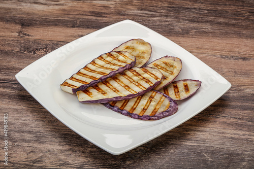 Grilled graffiti eggpant slices with oil photo